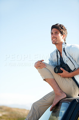 Buy stock photo Man, photographer and camera on car or smile for road trip, adventure or journey or thinking with travel. Person, photography or memories for vacation, holiday scenery on drive or blue sky in nature
