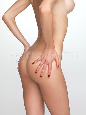 Buy stock photo Cropped rear view of a shapely woman's buttocks isolated on grey