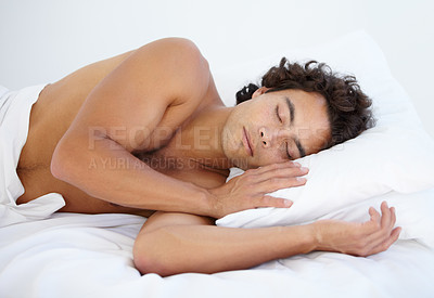 Buy stock photo Rest, calm and man sleeping in bed on a weekend in the morning with a fluffy pillow at his house. Relax, peaceful and male person taking a nap and dreaming in the bedroom of his home or apartment.