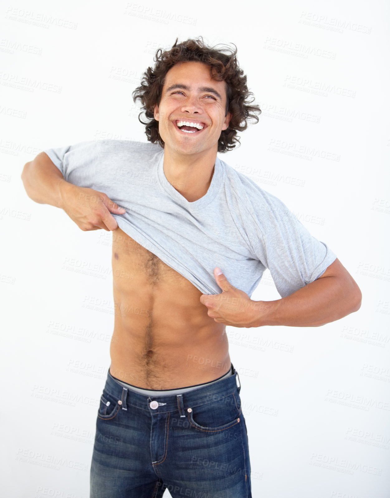 Buy stock photo Happy, laughing and a man dressing in studio on a gray background while changing clothes for summer. Smile, funny or clothing with a handsome young male person getting ready in a jeans and t-shirt