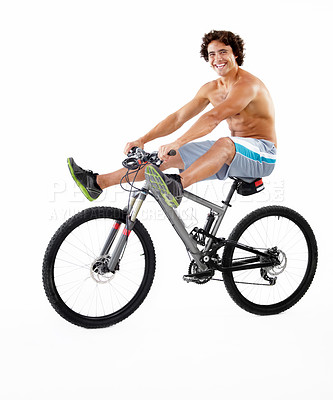 Buy stock photo A sexy young man riding his bike on a white background
