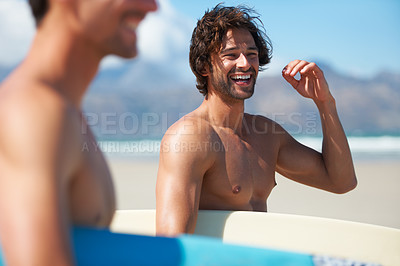 Buy stock photo Two friends making their way to the ocean, joking along the way