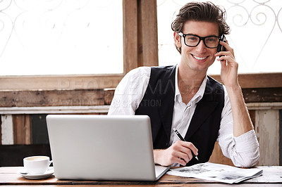 Buy stock photo A young man multi-tasking