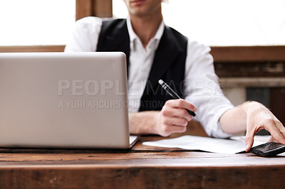 Buy stock photo Cropped image of a young man multi-tasking