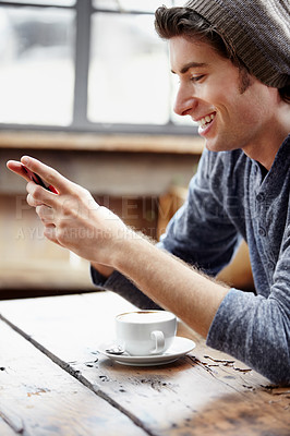 Buy stock photo Smile, cafe and man with a smartphone, typing and connection for social media, network and relax. Male person, happy guy and cellphone for texting, mobile app and online reading in a coffee shop