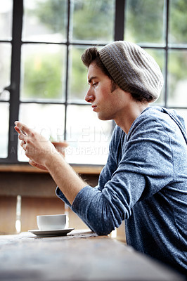 Buy stock photo Coffee shop restaurant, cellphone and relax man scroll, texting or typing email, phone message or social network post. Student cafeteria, morning wellness or serious person reading blog on smartphone