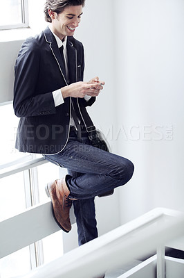 Buy stock photo Fashion, cellphone and young man networking on social media, mobile app or the internet with formal outfit. Smile, technology and male person scroll on a phone with classy, cool and elegant style.
