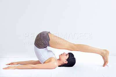 Buy stock photo Yoga, floor exercise and flexible woman stretching, agile and doing pose, wellness workout or fitness challenge. Studio, ground and pilates person warm up, training and exercise performance