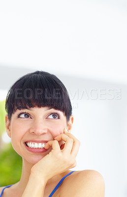 Buy stock photo Happy, smile and young woman at her home with positive, good and confident attitude or mindset. Happiness, excited and female person from Canada biting her nail and thinking in her modern house.