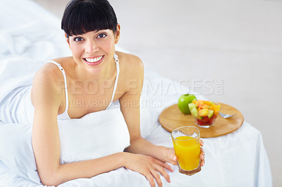 Buy stock photo Woman, portrait and juice for breakfast in bed with glass drink, fresh beverage or morning hydration liquid. Organic fruits, healthy lifestyle or happy person thirsty, smile and relax in home bedroom