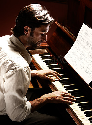 Buy stock photo Profile of a handsome man playing the piano