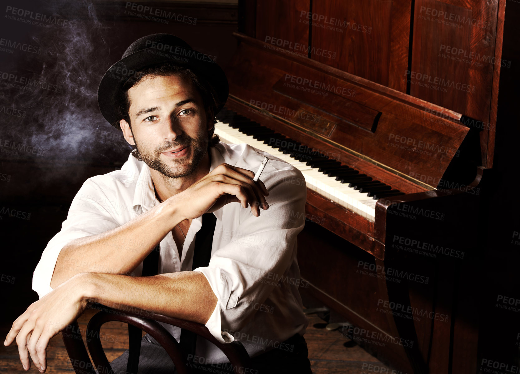 Buy stock photo Portrait, artist and man with a piano, smoking and creative with talent, performance and gig. Face, musician and club with a cigarette, jazz and ambient with tobacco, smile and confident player