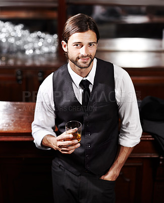 Buy stock photo Portrait of a well-dressed young man sitting at a bar with a drink