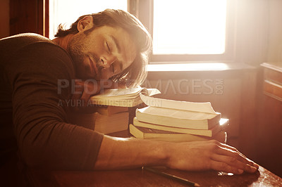 Sleeping, tired and man with books, student and fatigue with education, university and burnout. Person, academic and guy with literature, novel and exhausted with lens flare, insomnia and dreaming