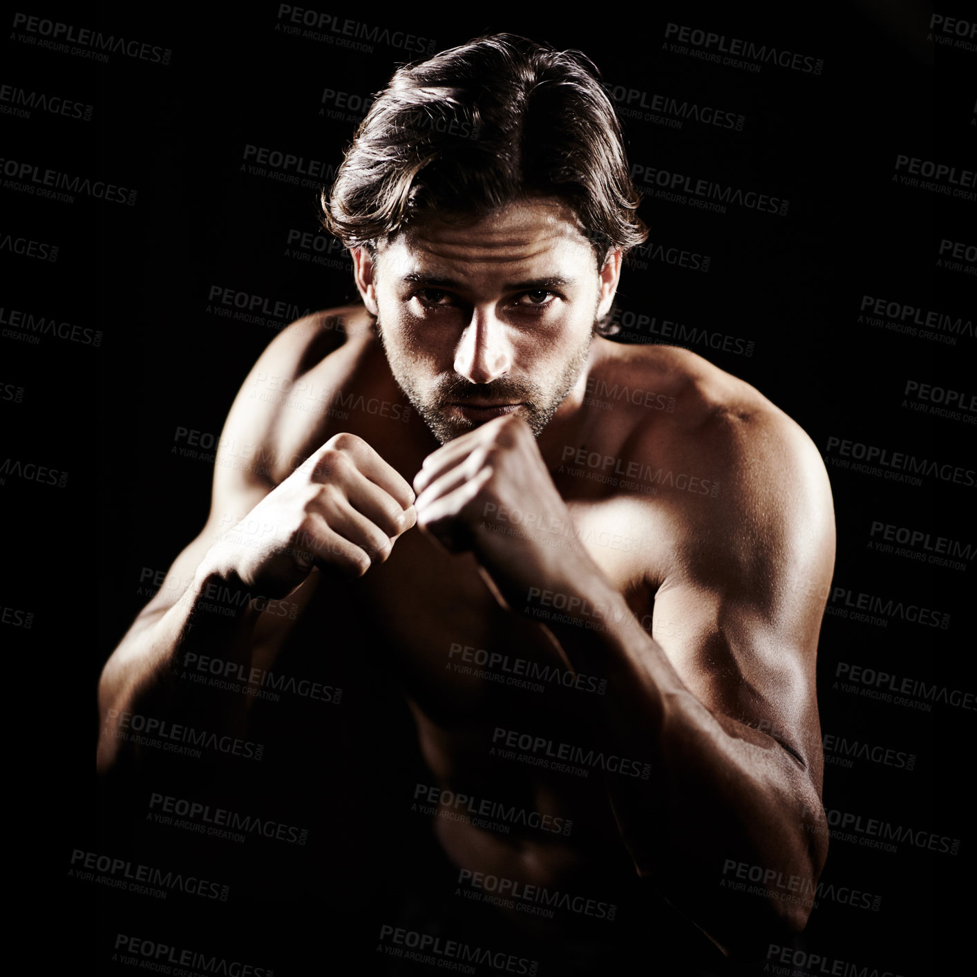 Buy stock photo Portrait of a muscular young boxer standing ready to fight