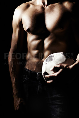 Buy stock photo Muscle, body and hands of athlete with football in studio isolated on a black background. Strong, abs and man with soccer ball for sports, training and sexy workout, exercise and fitness for health
