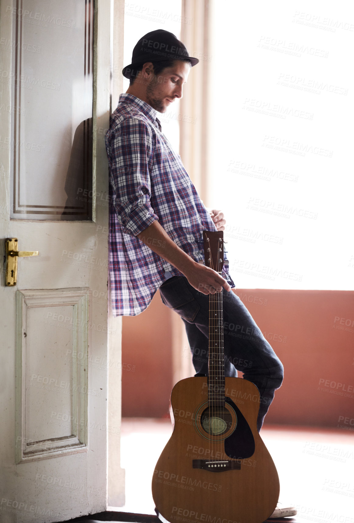 Buy stock photo Musician, waiting and man with a guitar, instrument and singer in a music studio. Creative, artist and guitarist standing in home and thinking of performance, equipment or listening to audio of band