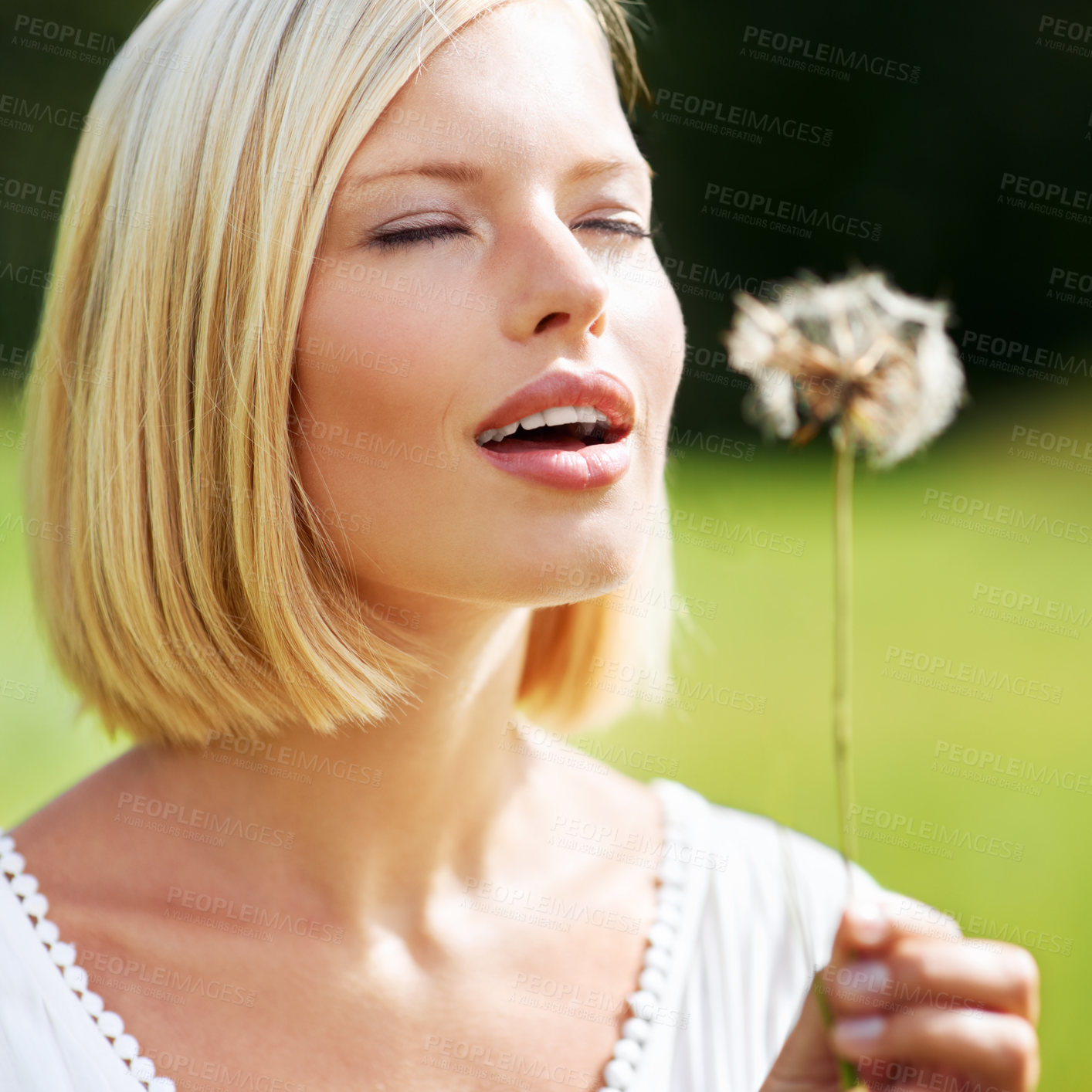 Buy stock photo Nature, freedom and woman blowing dandelion on a field with hope, wish or optimism. Face, eyes closed and female person on park with flower, peace and superstition while traveling in the countryside