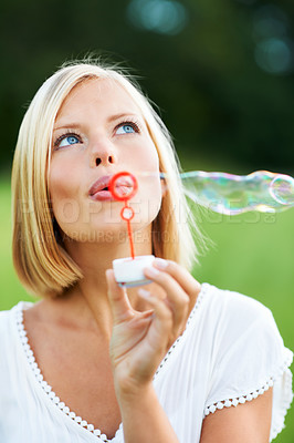 Buy stock photo Woman, thinking and blowing bubbles in nature for fun day or playing at outdoor park. Face of female person or blonde in wonder with stick or wand to blow bubble on playful holiday or summer break