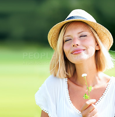 Buy stock photo Woman, park and peace with thinking, flower and eyes closed with peace, relax and memory outdoor in summer. Girl, garden or backyard with plant, scent and smile for spring in countryside with hat