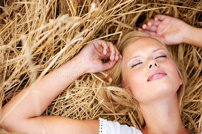 Buy stock photo Relax, freedom and woman lying on wheat field outdoor for adventure, journey or travel experience from above. Top view, face and female person with eyes closed resting in grass with stress free peace