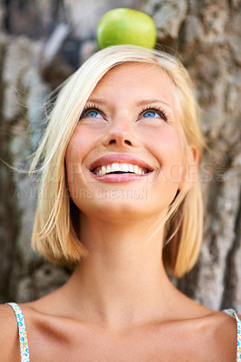 Buy stock photo Woman, face and thinking with smile for apple by tree in natural nutrition, diet or health and wellness in nature. Female person with organic green fruit in wonder for healthy vitamin, snack or meal