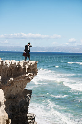 Buy stock photo Thinking, cliff and business man on rock by ocean for depression, problem solving and solution. Professional, bankruptcy and confused corporate worker on edge for danger, risk and fail in company