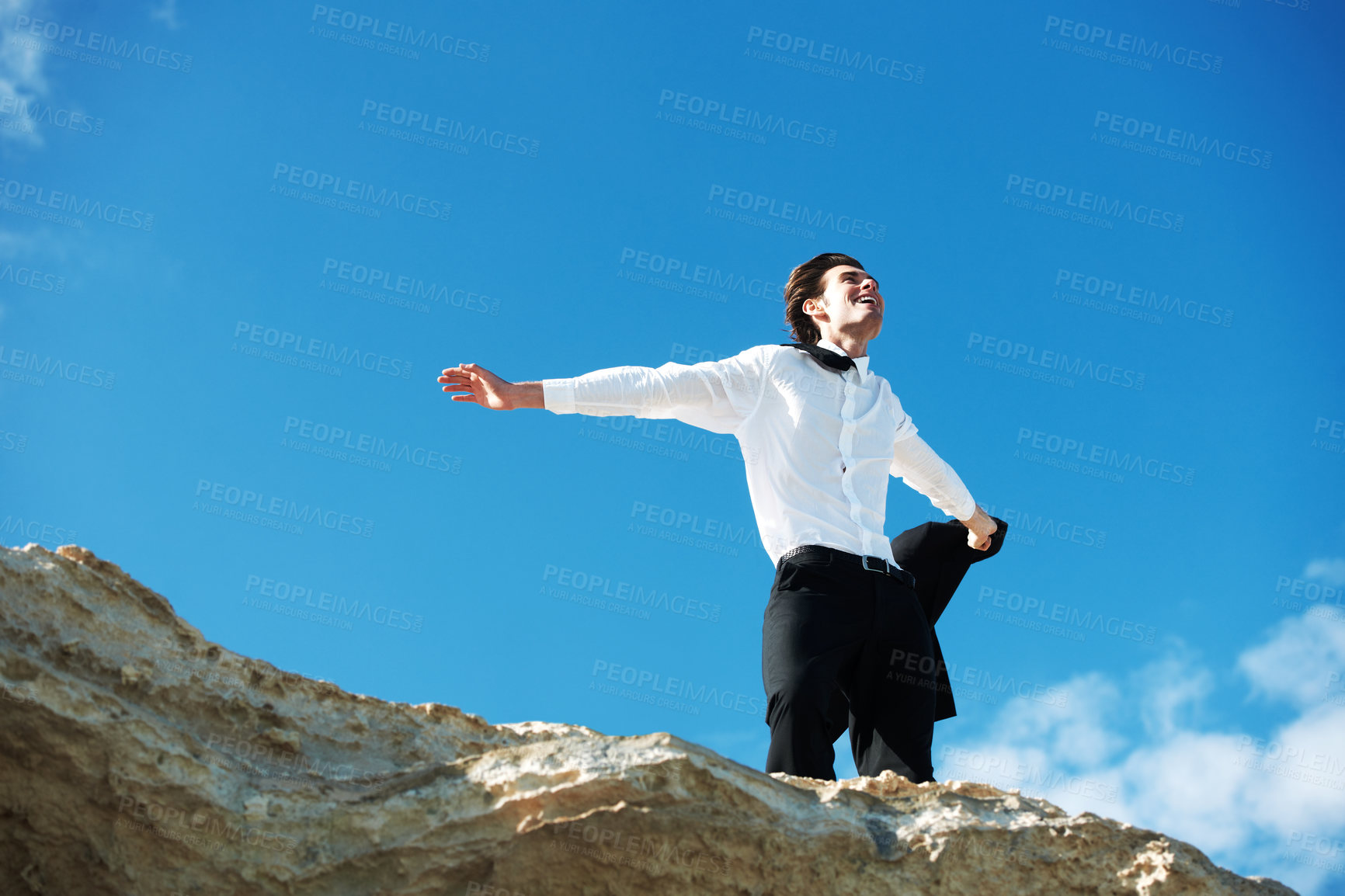Buy stock photo Cliff, freedom or happy business man in celebration of success or victory on holiday vacation. Sky background, goal or excited employee winner on mountain with achievement or job promotion in suit