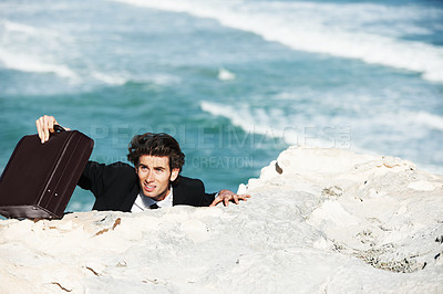 Buy stock photo Climbing, outdoor cliff or businessman with stress for job, career opportunity or work in a beach. Professional, briefcase or tired corporate worker hanging on edge with anxiety, depression or danger