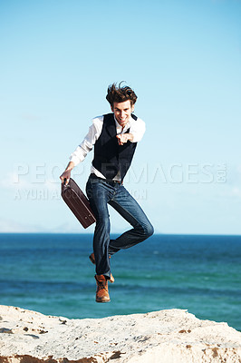 Buy stock photo Portrait, seaside and jump with man, briefcase and excited with happiness, vacation and business. Happy person, employee or winner with ocean background, beach or activity with celebration or holiday