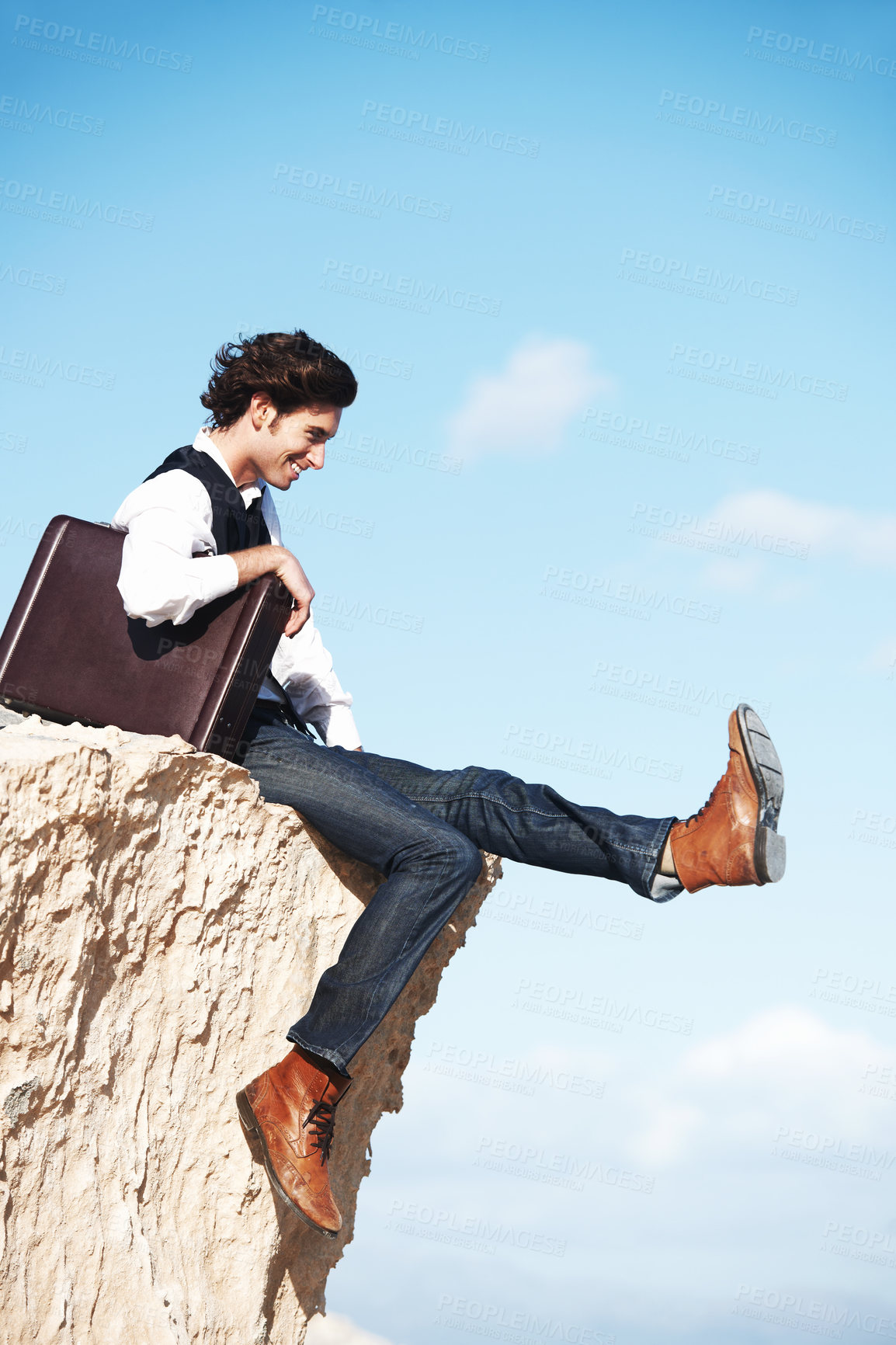 Buy stock photo Businessman, thinking and sitting on cliff with smile for freedom by looking at sky with briefcase. Young person, happiness and excited for startup career with leg kick with mockup for new idea