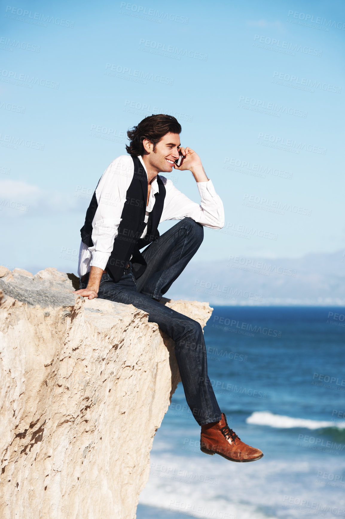Buy stock photo Cliff, edge and man with a happy phone call at the ocean, beach or connection on vacation, travel or social media. Businessman, contact and edgy chat on cellphone, communication or talking above sea