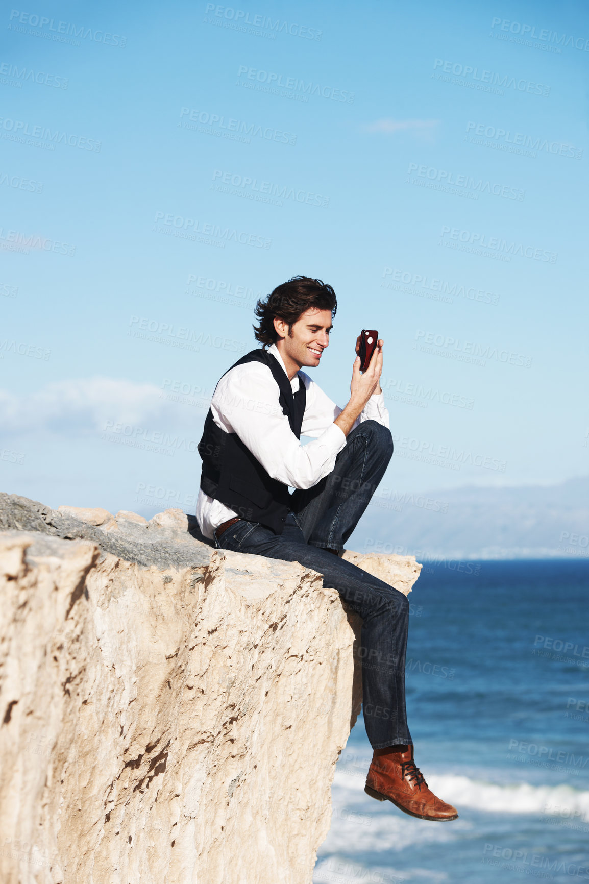 Buy stock photo Cliff, edge and man with a phone at the ocean, beach or happy connection on vacation, travel or social media. Businessman, contact and edgy chat with cellphone, communication or internet above sea
