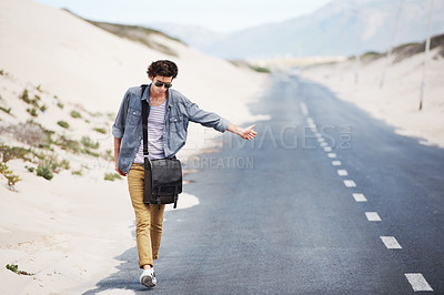 Buy stock photo Man, road and walking in hitchhike for lift, pickup or transportation down street or sidewalk. Male person hitchhiking with thumbs up, sign or signal for emergency or travel on deserted outdoor path
