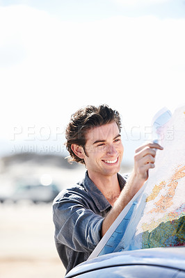 Buy stock photo Road map, car and young man with smile for weekend trip, vacation or holiday in countryside. Happy, vehicle and male person from Canada reading for travel, transport and outdoor adventure or journey.