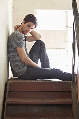 Buy stock photo Thinking, depression and lonely with a man on a staircase in his home, sitting on the landing by a window. Idea, mental health and relax with a handsome young male on steps or stairs in his house