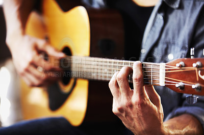 Buy stock photo Cropped view of masculine hands strumming a guitar