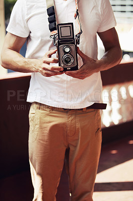 Buy stock photo Young male photographer in the city with a vintage camera