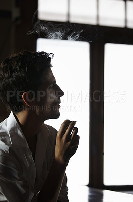 Buy stock photo Smoking, man and thinking in pub with cigarette or male model or vapor customer and smoker unhealthy on bokeh. Habit, addiction and male person with tobacco or in thought or relaxing and in a club
