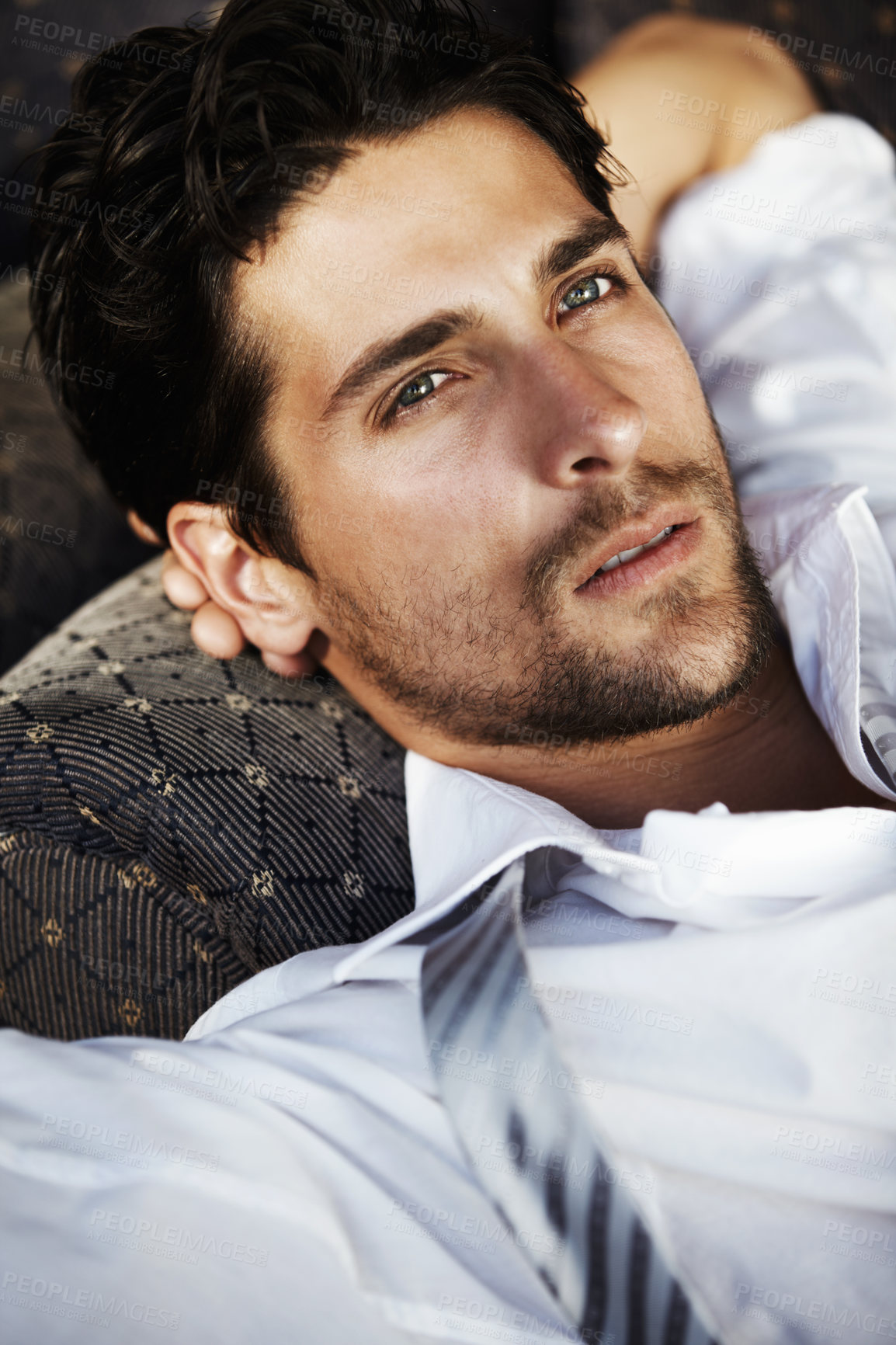 Buy stock photo Young attractive male resting on sofa after a day at the office