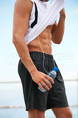 Buy stock photo Person, abs and fitness, water and wipe sweat with bottle and wellness, runner outdoor for cardio and break after workout. Hydration, h2o and training with health, stomach muscle and sports athlete