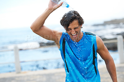 Buy stock photo Man, fitness and pouring water on head to hydrate, laughing and fun in cardio training. Happy male athlete, liquid and refreshment from exercise, workout and running by ocean, sea and outdoor play