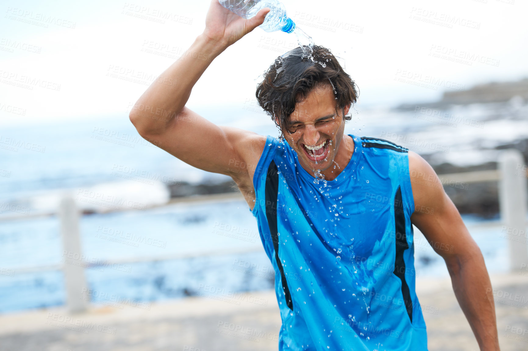 Buy stock photo Man, fitness and pouring water on head to hydrate, laughing and fun in cardio training. Happy male athlete, liquid and refreshment from exercise, workout and running by ocean, sea and outdoor play