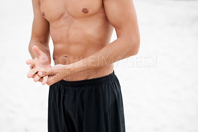 Buy stock photo Cropped image of an attractive man standing shirtless showing his abdominal muscles