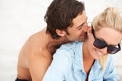 Buy stock photo Couple, sitting and hug relax on beach sand for holiday happy romance, playful fun or outdoor vacation. Man, woman or sunshine lovers at sea for summer partnership, tropical smile or date memories