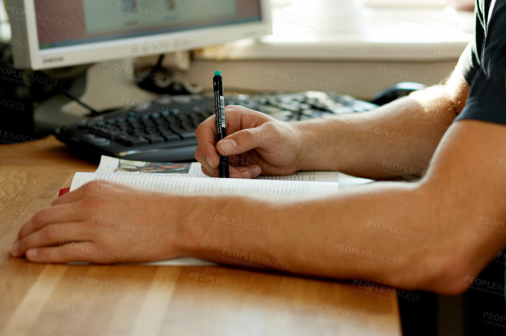 Buy stock photo Hands, education and a pen for homework with a person at a desk in their home for learning or development. Study, writing and book with a student closeup in an apartment for university research