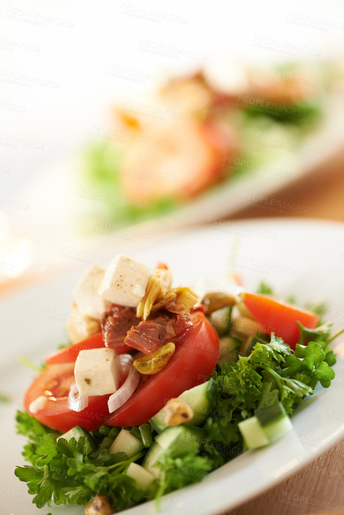 Buy stock photo Plate, closeup and a salad on a table for lunch, nutrition or eating to a a diet. Zoom, health and vegetable, dinner and an arrangement of food for detox, cooking or hungry with a dish for brunch