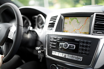Buy stock photo Cropped shot of a person traveling by car using the on-board GPS to navigate