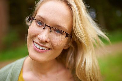 Buy stock photo Woman, portrait and glasses in garden with smile, sunshine and relax for leisure in nature. Norway, person or beauty face with natural glow in countryside, healthy or spectacles for trendy aesthetic