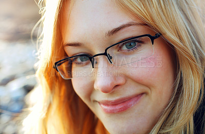 Buy stock photo Young blond woman with glasses smiling at the camera